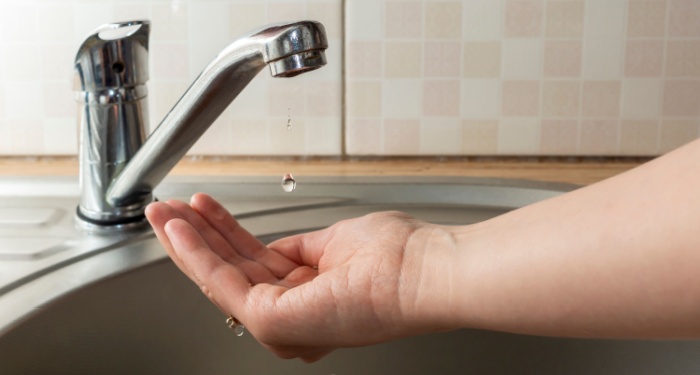 dripping tap with hand