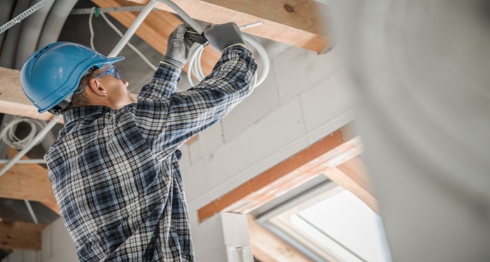 Man wiring in loft