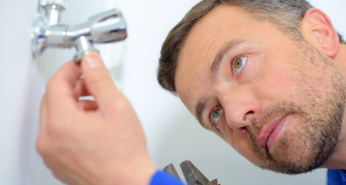 man fixing washer