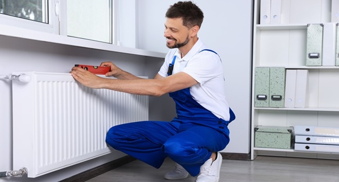 man installing radiator