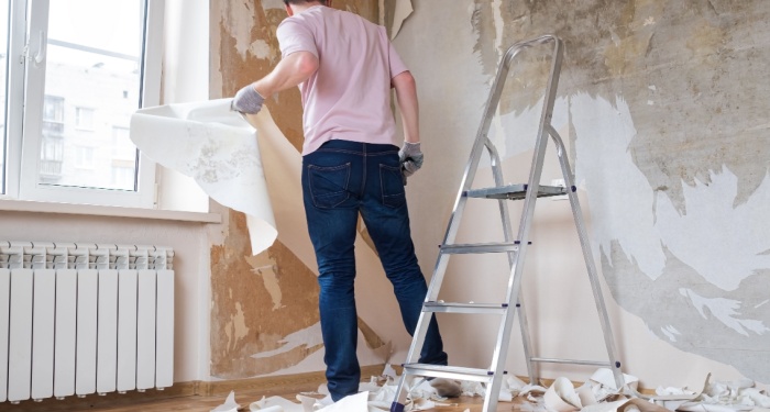 man removing wallpaper