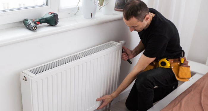 person fixing radiator