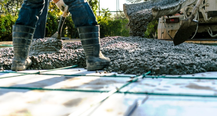 person pouring concrete