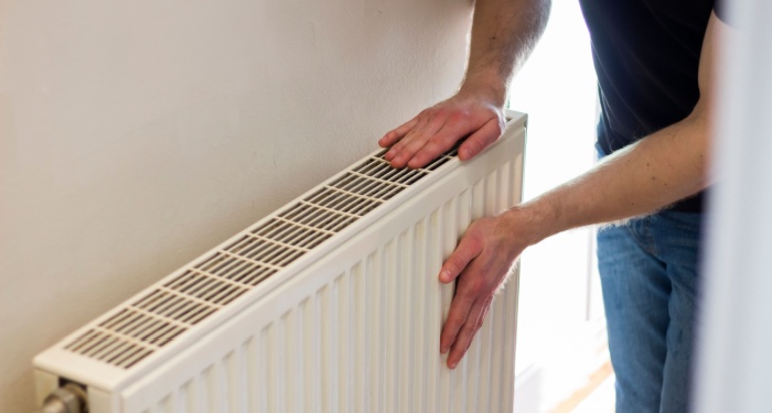 person touching radiator