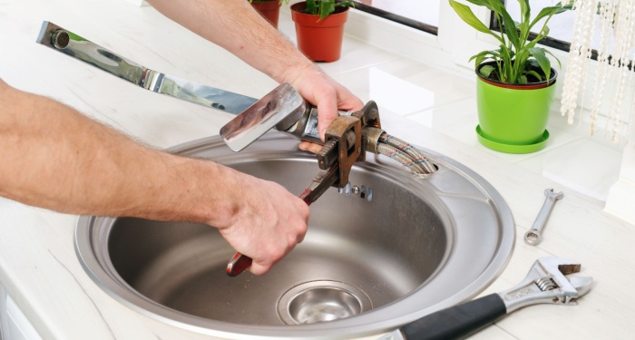 man fixing tap