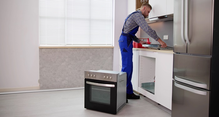 person fitting electric cooker