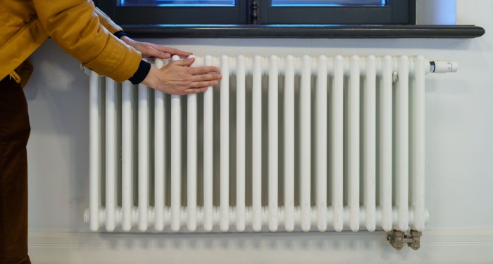 woman touching radiator